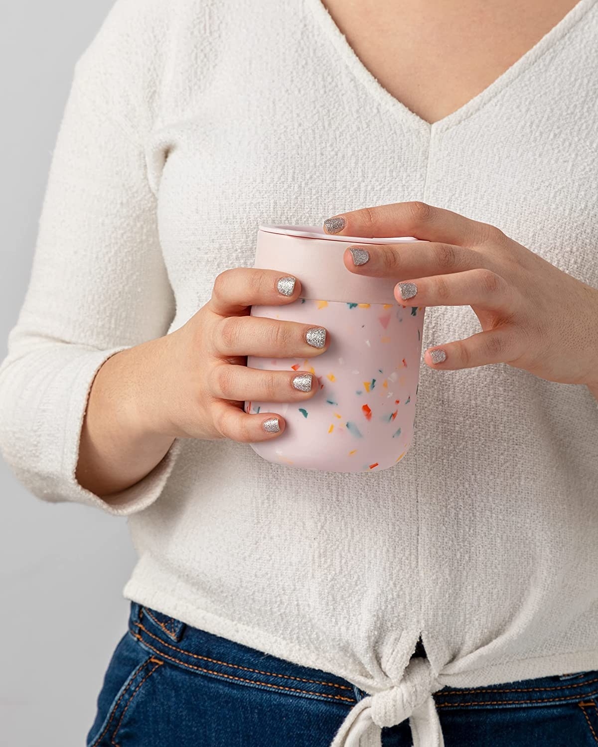 a person holding the silicone wrapped drink tumbler