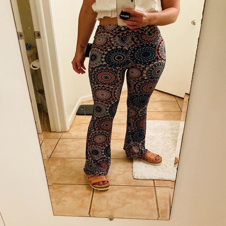 Reviewer photo of them wearing flared leggings with mandala print
