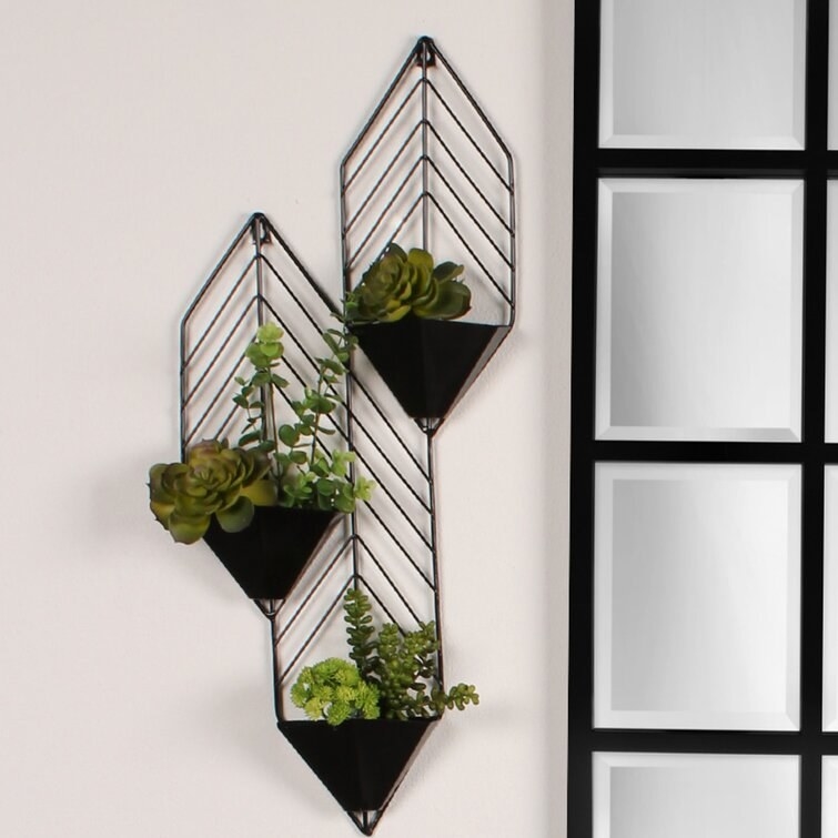 Product image of three black triangular wall planters filled with succulents