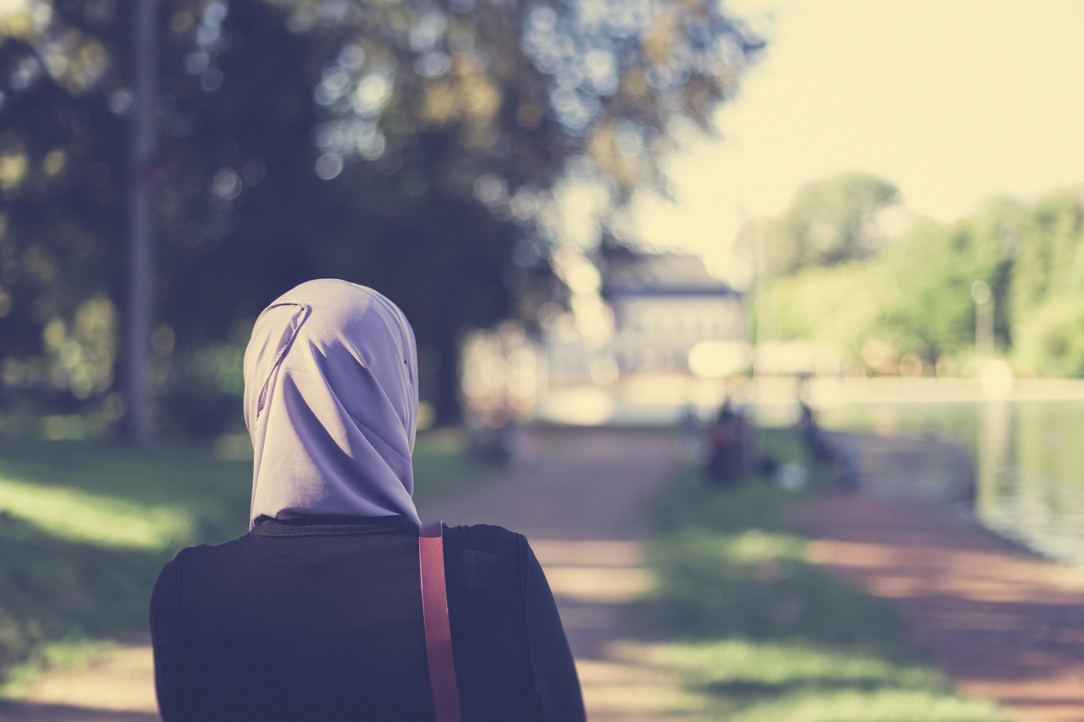 A Muslim woman walking down a path