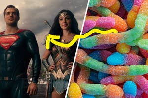 Superman stands proudly next to Wonder Woman and a close up of colorful sour worm candy