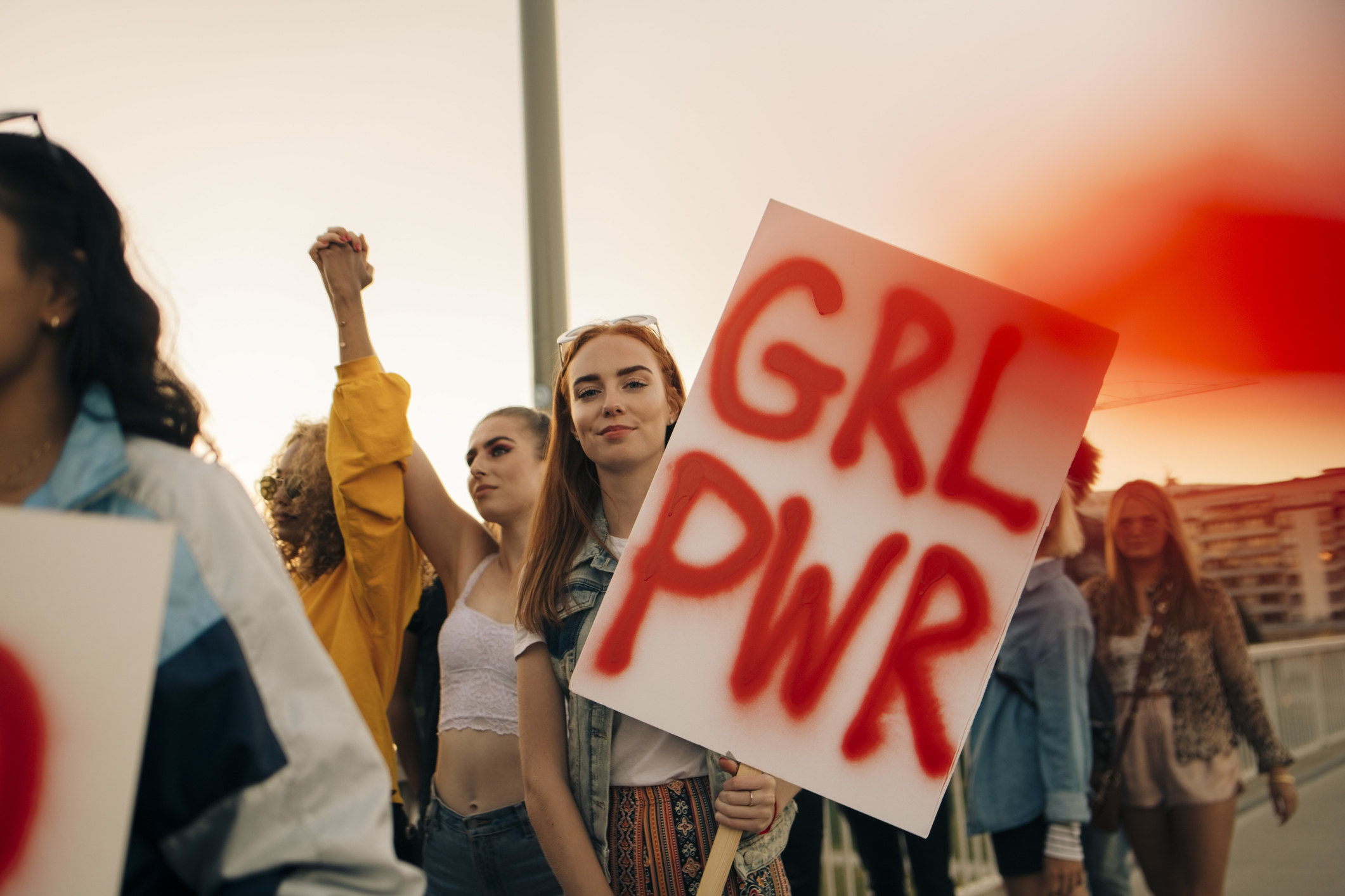 Group of empowered women holding a GRL PWR sign
