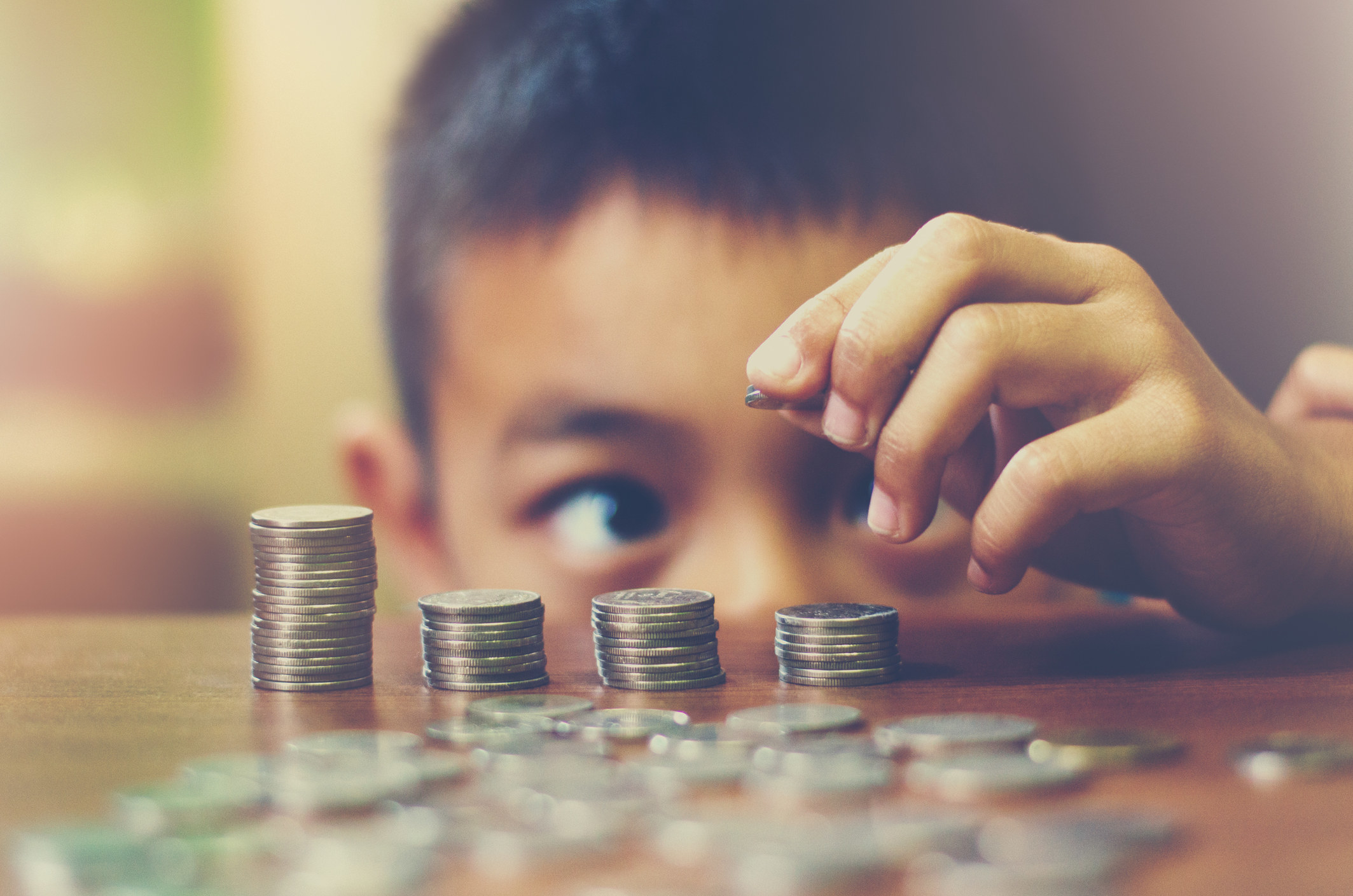 Little boy counting coins