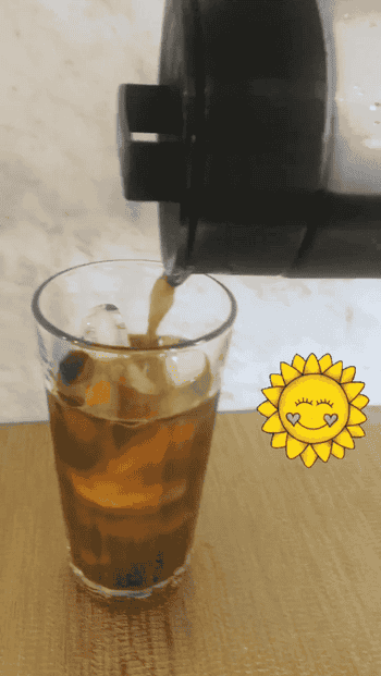 GIF of Maitland pouring cold brew coffee into a glass filled with ice