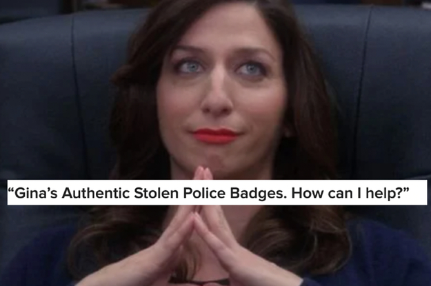 A close up of Gina Linetti as she sits with her hands folded together