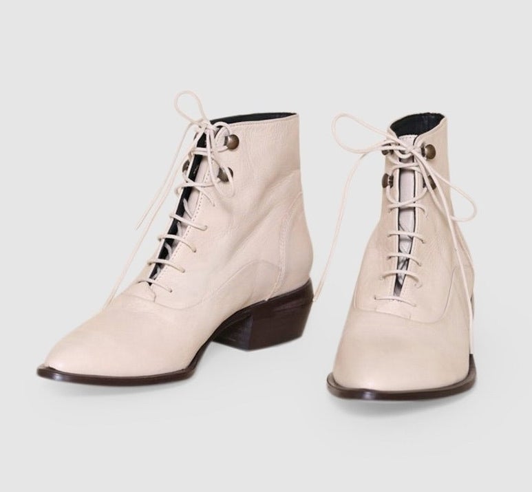 The cream lace up boots with a pointed toe and short blocked heel