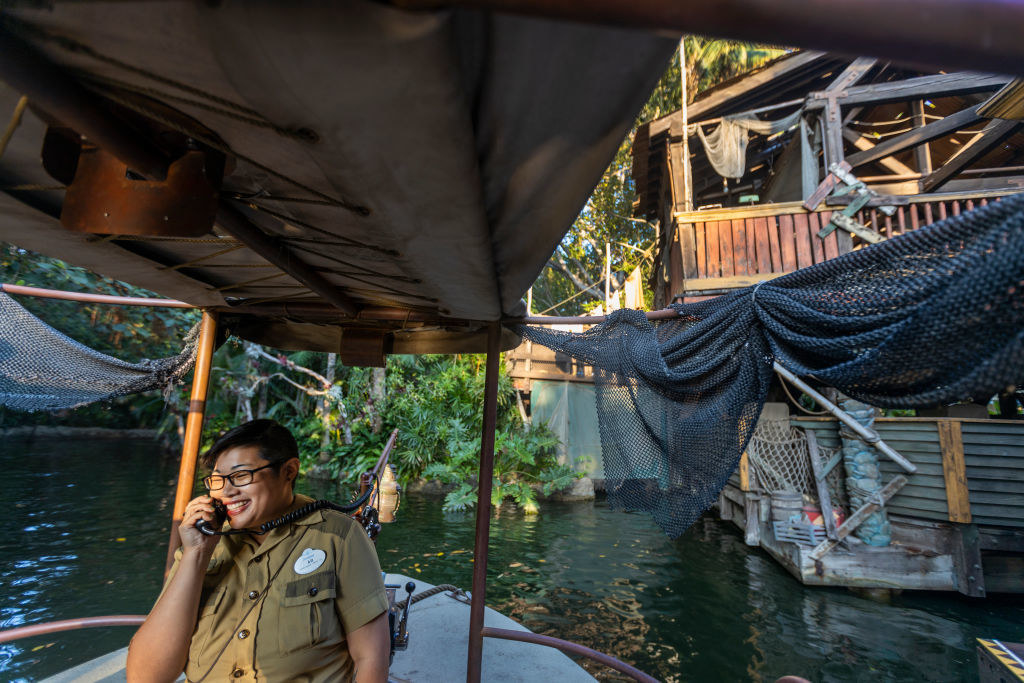 A cast member piloting a boat on the Jungle Cruise ride