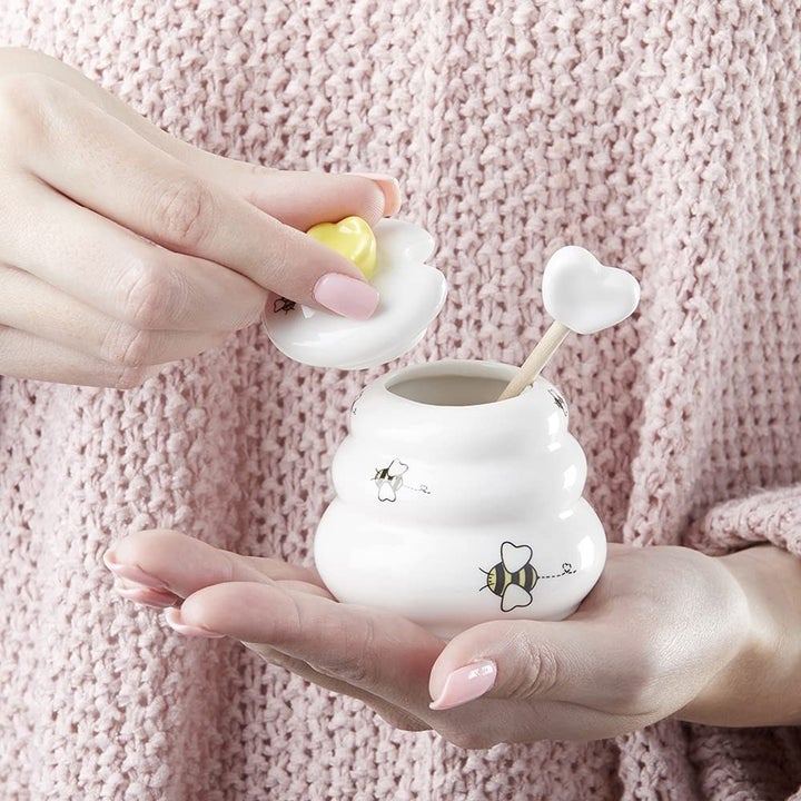 Image of model holding honey pot
