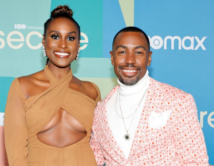 Issa on the left posing with Prentice at a red carpet event for Insecure