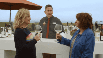 Amy Poehler and Rachel Dracht toasting glasses of wine
