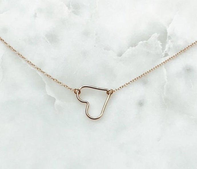 A chain necklace with an open heart charm.