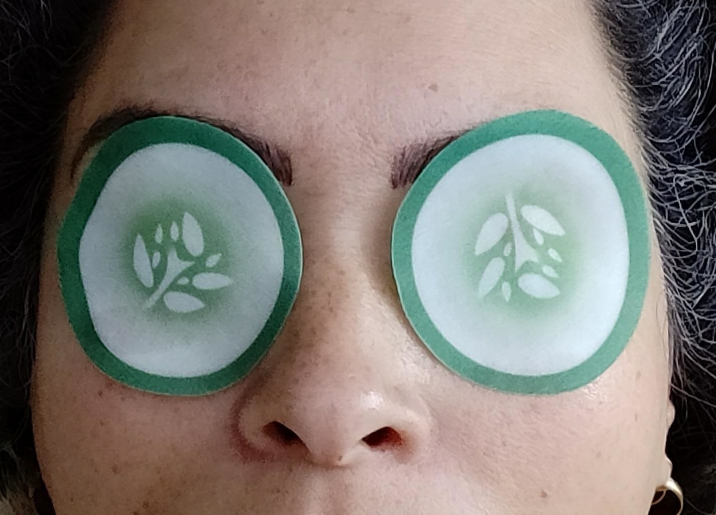 reviewer wearing the thin cucumber slice shaped eye patches