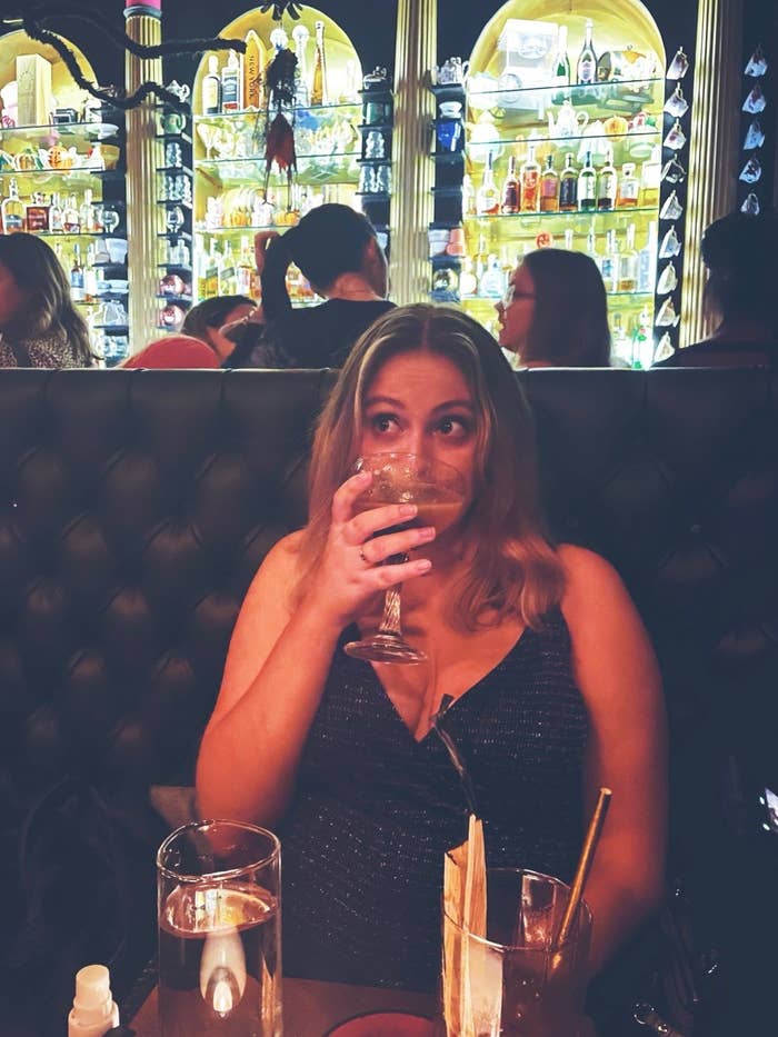 woman in a bar sipping a cocktail