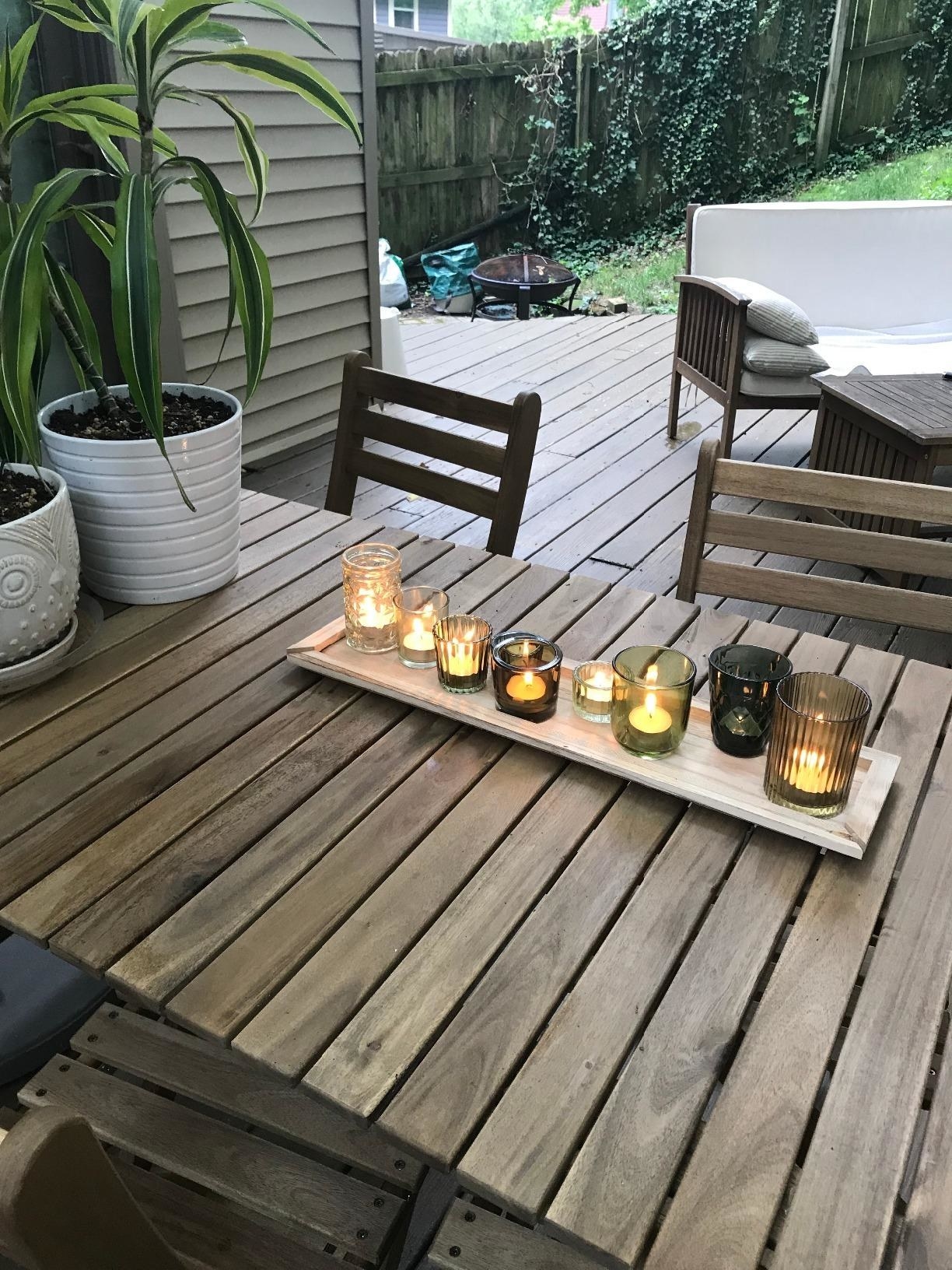 Reviewer&#x27;s votive set with tray is displayed outside on a wooden table
