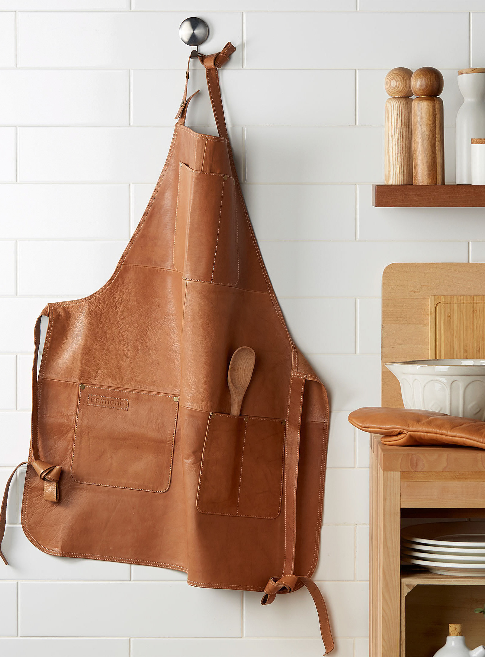 a large leather apron hung on a hook in a rustic kitchen