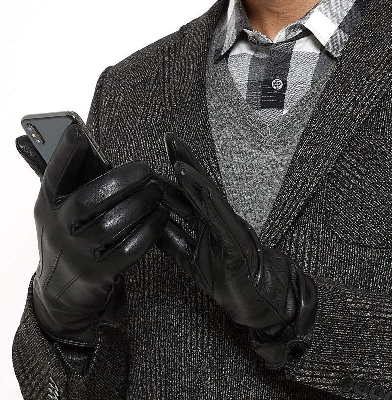 someone wearing the leather gloves while texting on their phone