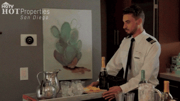 A man pushing a cart with food and drinks on it, thinking &quot;So ready for a new job.&quot;
