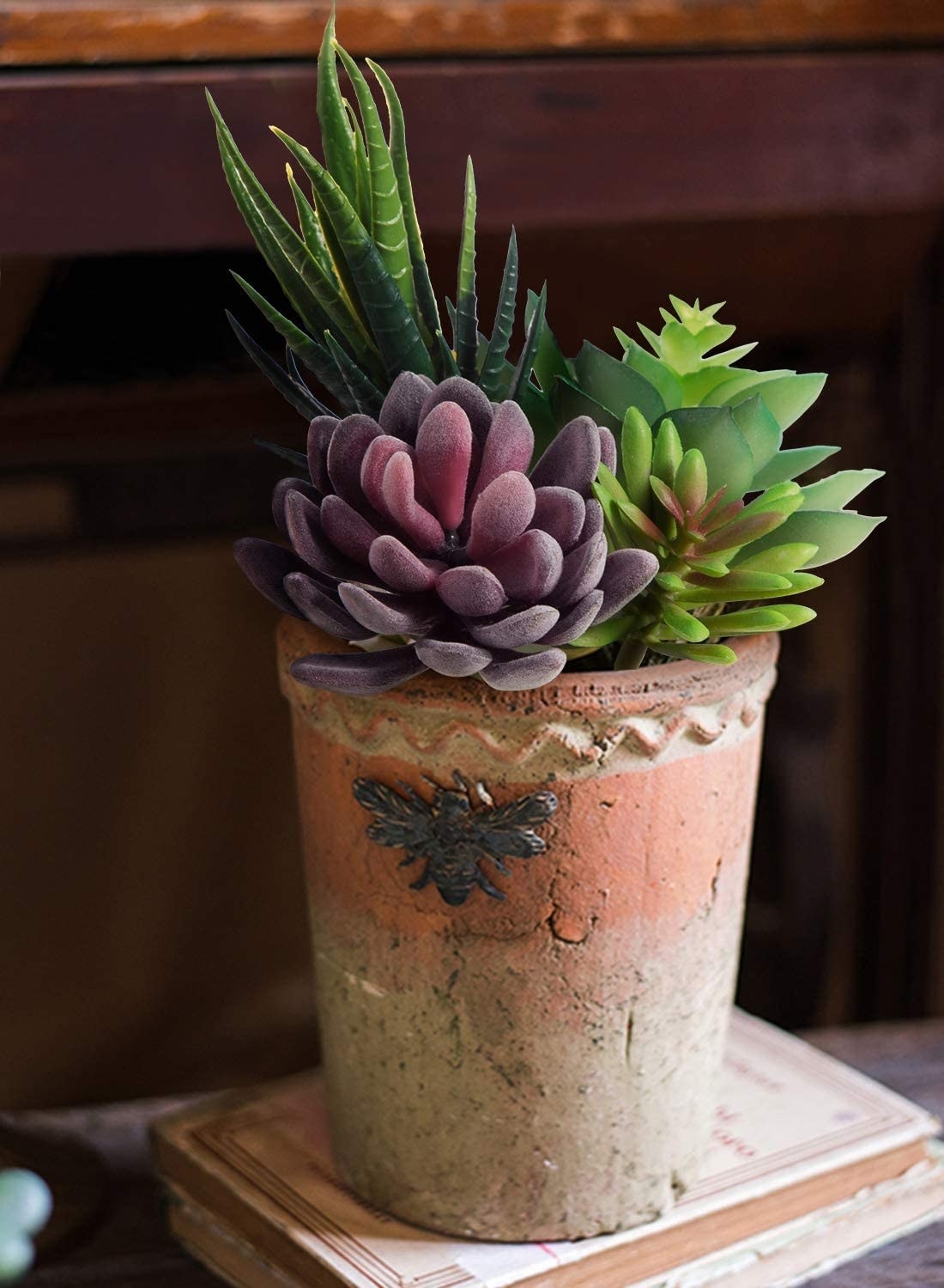 a trio of faux succulents potted in a terracotta planter