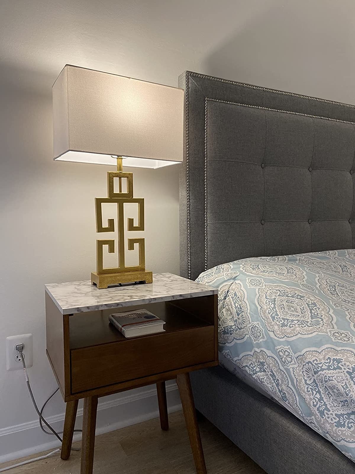 Reviewer&#x27;s lamp sits on a nightstand