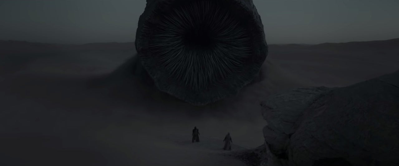 Paul and Jessica facing a sandworm in "Dune"