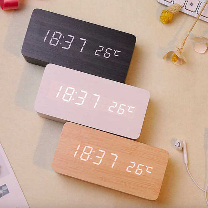 a flatlay of minimalist wooden alarm clocks