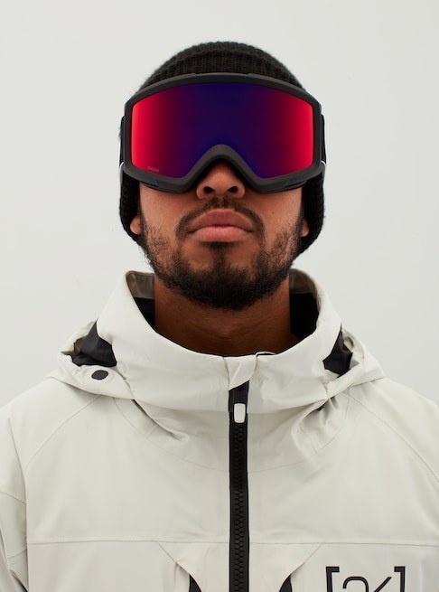 A male model wearing the red/black goggles with winter coat