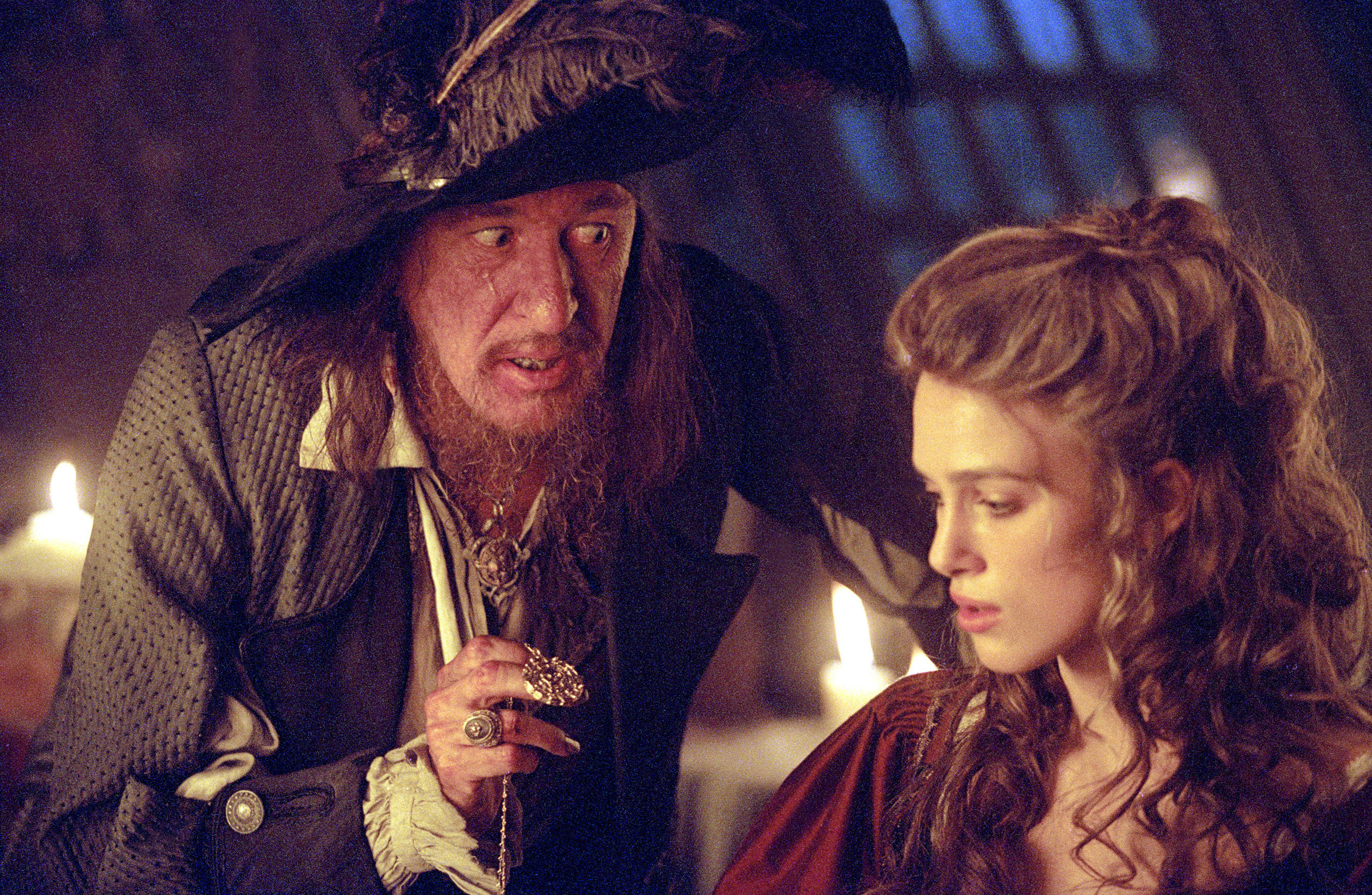 Geoffrey Rush talks to Keira Knightley in his pirate ship