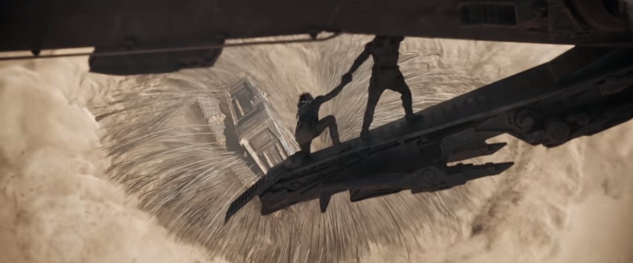 Paul and co. flying away from a sandworm in "Dune"
