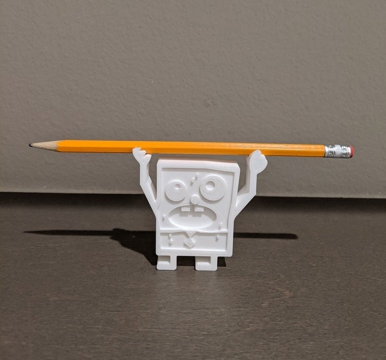 white doodlebob figure holding a pen