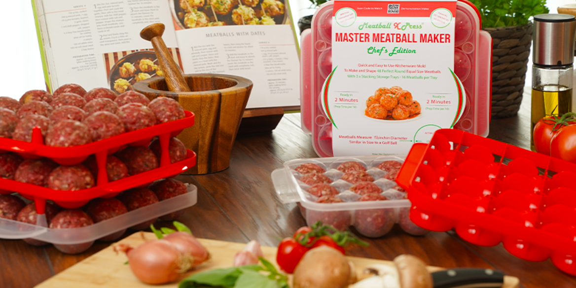 three meatball storage trays stacked on top of each other sitting on a wooden table with a recipe book