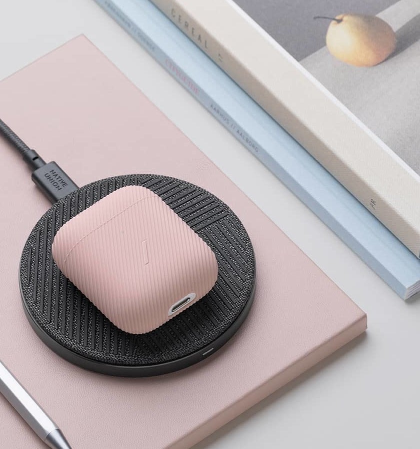the circular wireless charger powering up a pair of airpods
