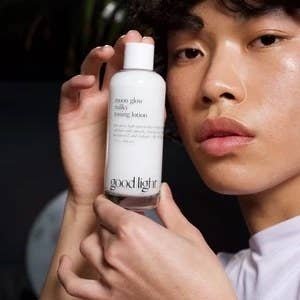 Model holding a bottle of the toning lotion