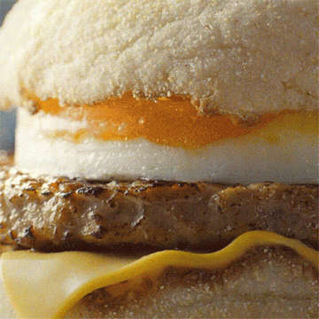 Sausage and egg McMuffin bun lifted to add a hash brown