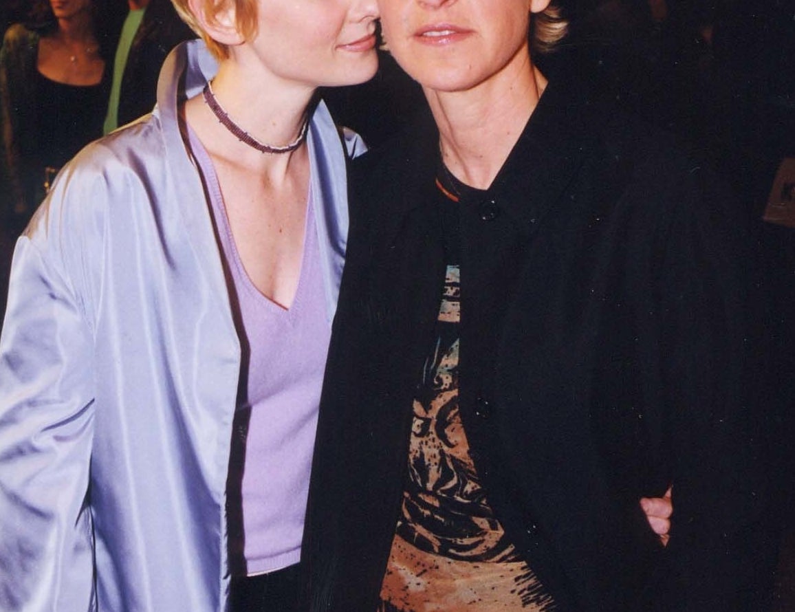 Anne puts her face close to Ellen while at an event