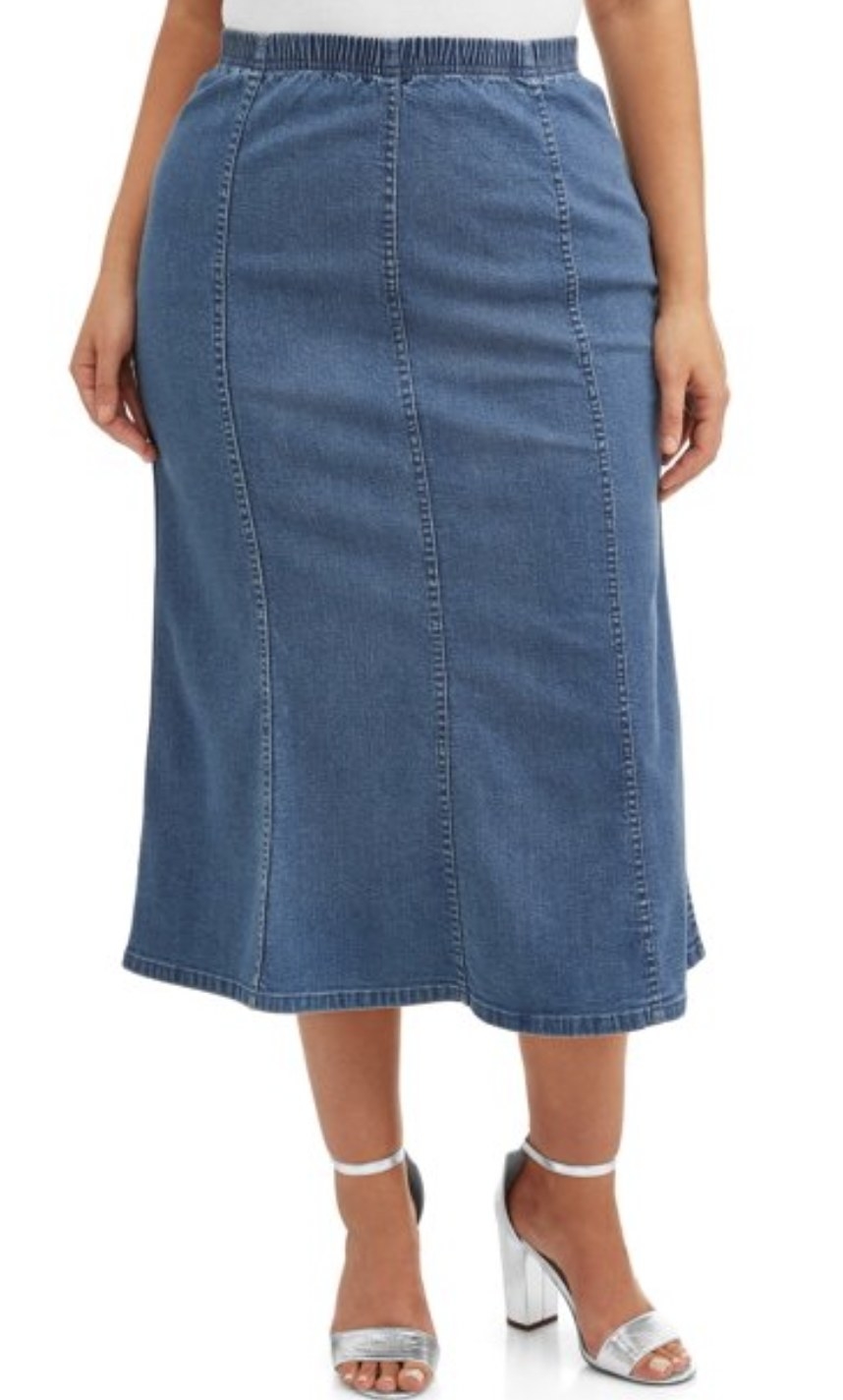 a front view of a model wearing the denim skirt that flares at the end