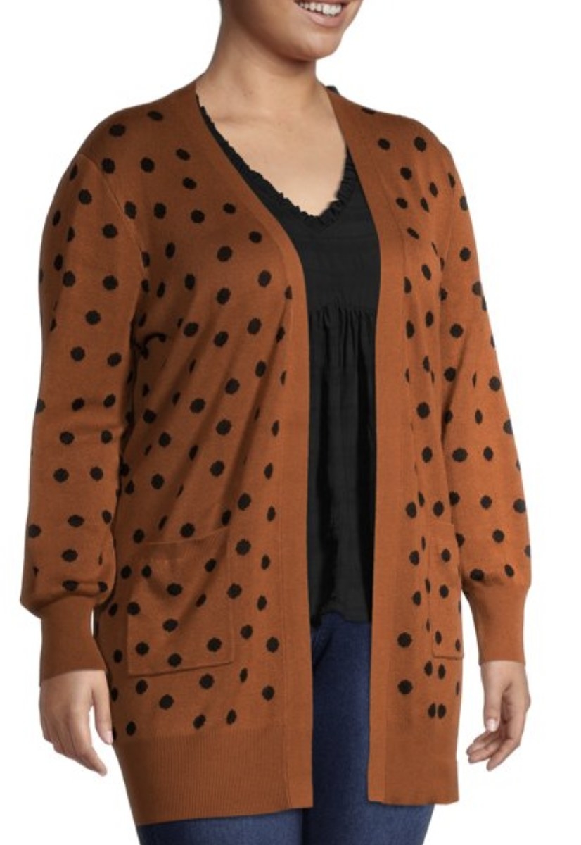 a person wearing a brown cardigan with black polka dots