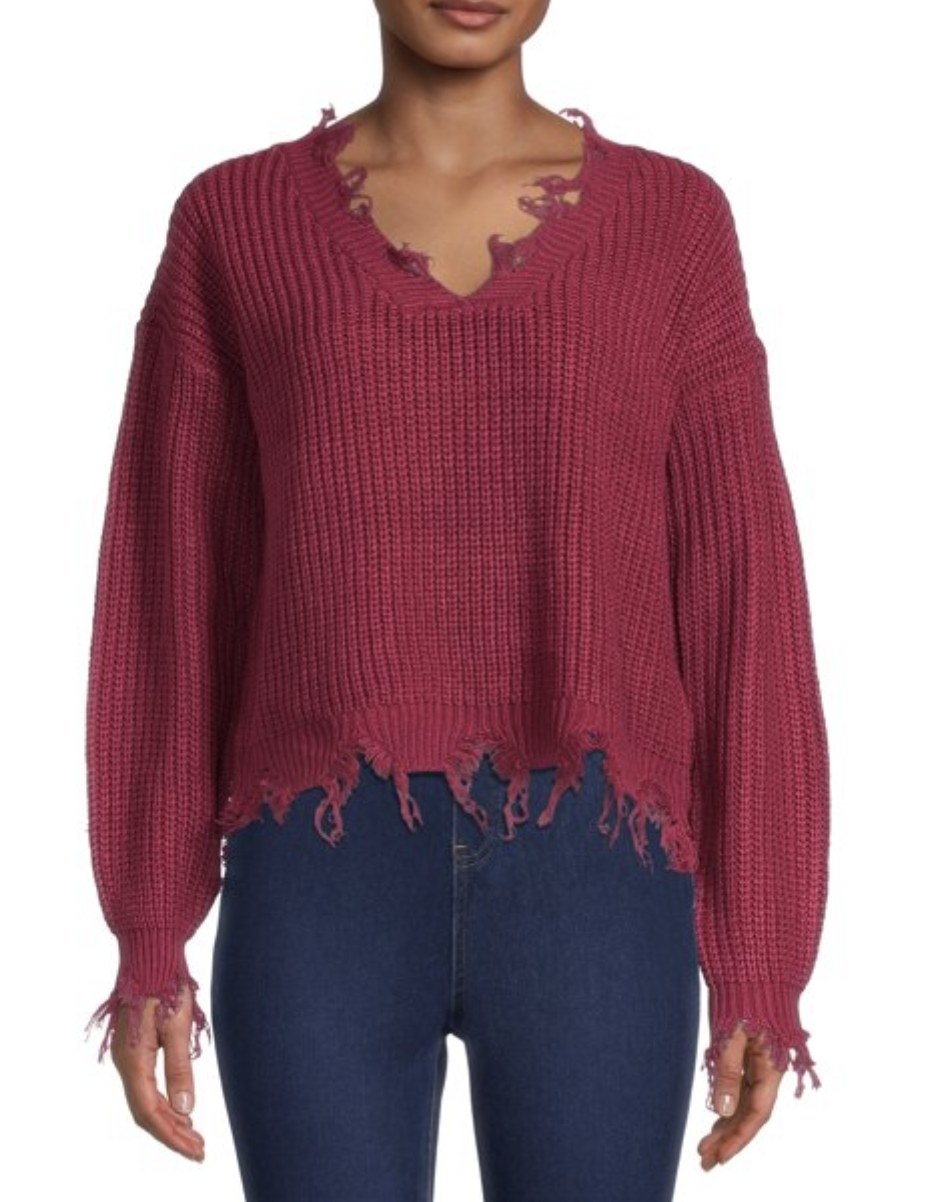 Model wearing the sweater in a plum color