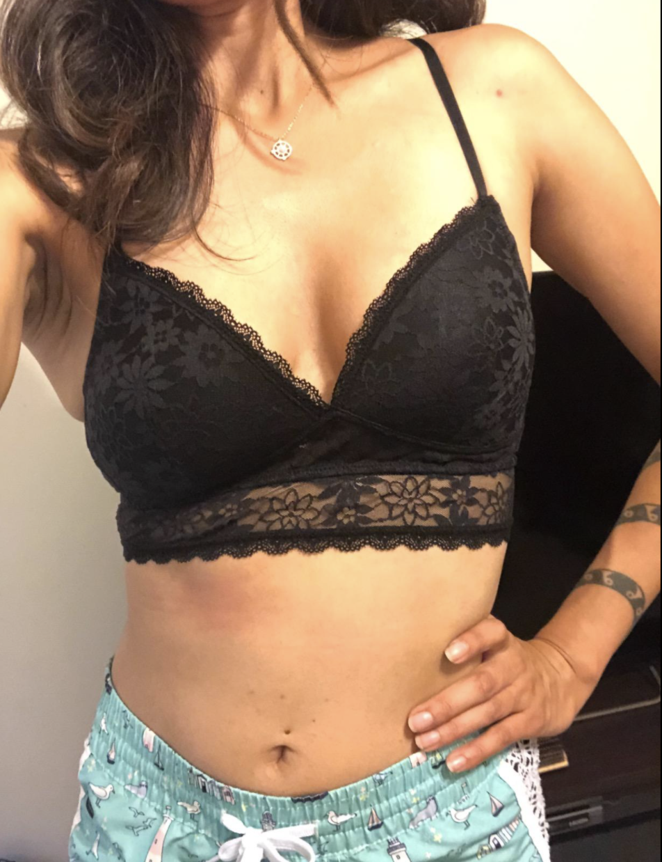 Reviewer in V-neck black lace bralette