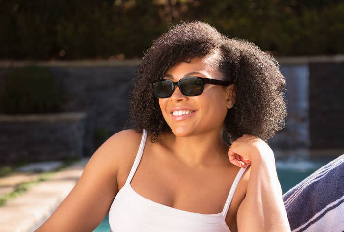 Woman relaxing by the pool sports Echo Frames on sunny day