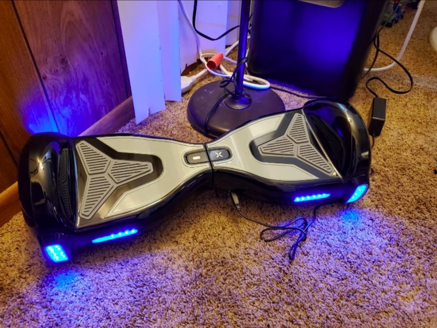 A reviewer&#x27;s photo of the grey and blue hoverboard in their home