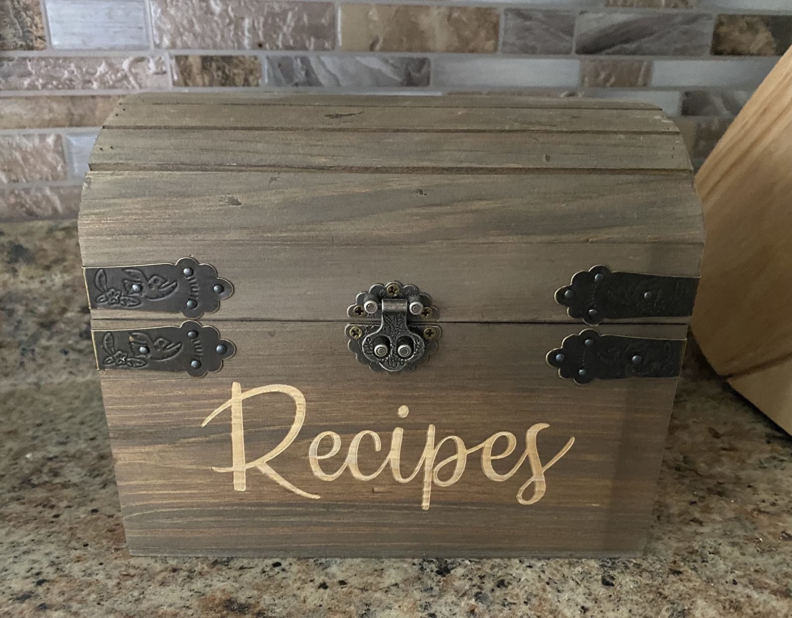 the wooden recipe box with a metal clasp and the word &quot;recipes&quot; written in light cursive on the front