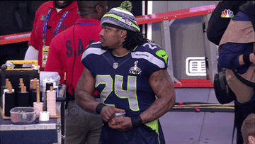 Marshawn Lynch eats a Tupperware of skittles on the sideline