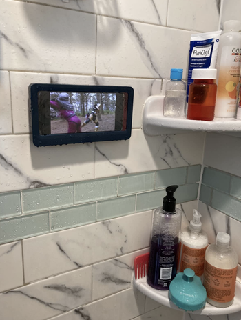 reviewer watching a tv show while in their shower