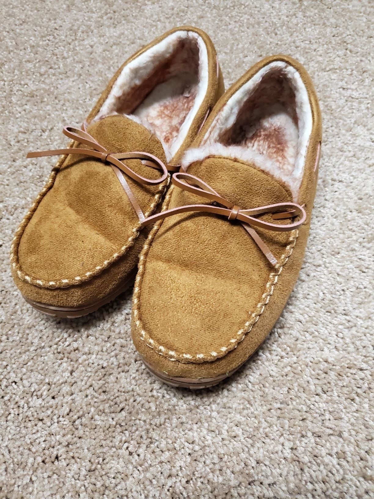 the light brown moccasins with ties on top and white fuzzy insides