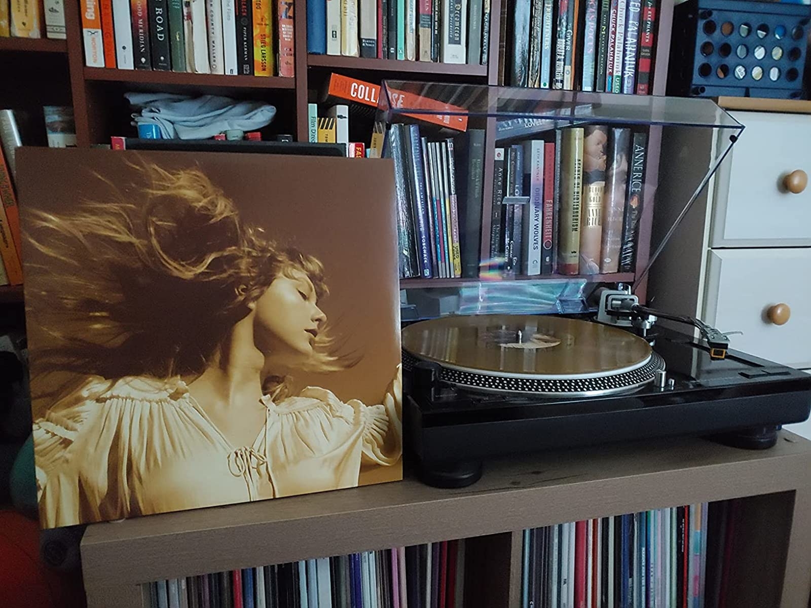 taylor switft&#x27;s &quot;fearless (taylor&#x27;s version)&quot; in gold album cover standing next to a record player with the gold vinyl record in the player