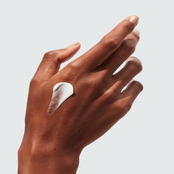Model's hand with a dab of the retinol
