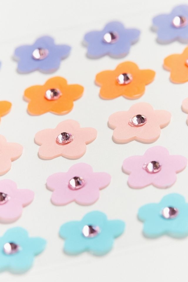 the purple, orange, pink, peach, and blue flower shaped patches each with a pink rhinestone in the middle