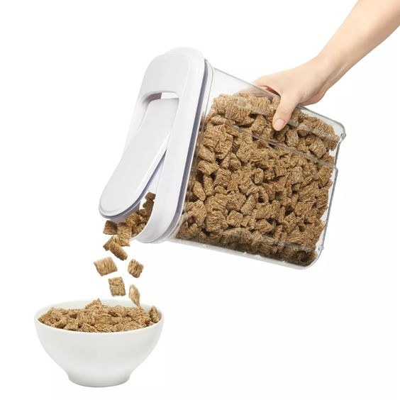 model pouring cereal from the tall, slender container with a pop lid
