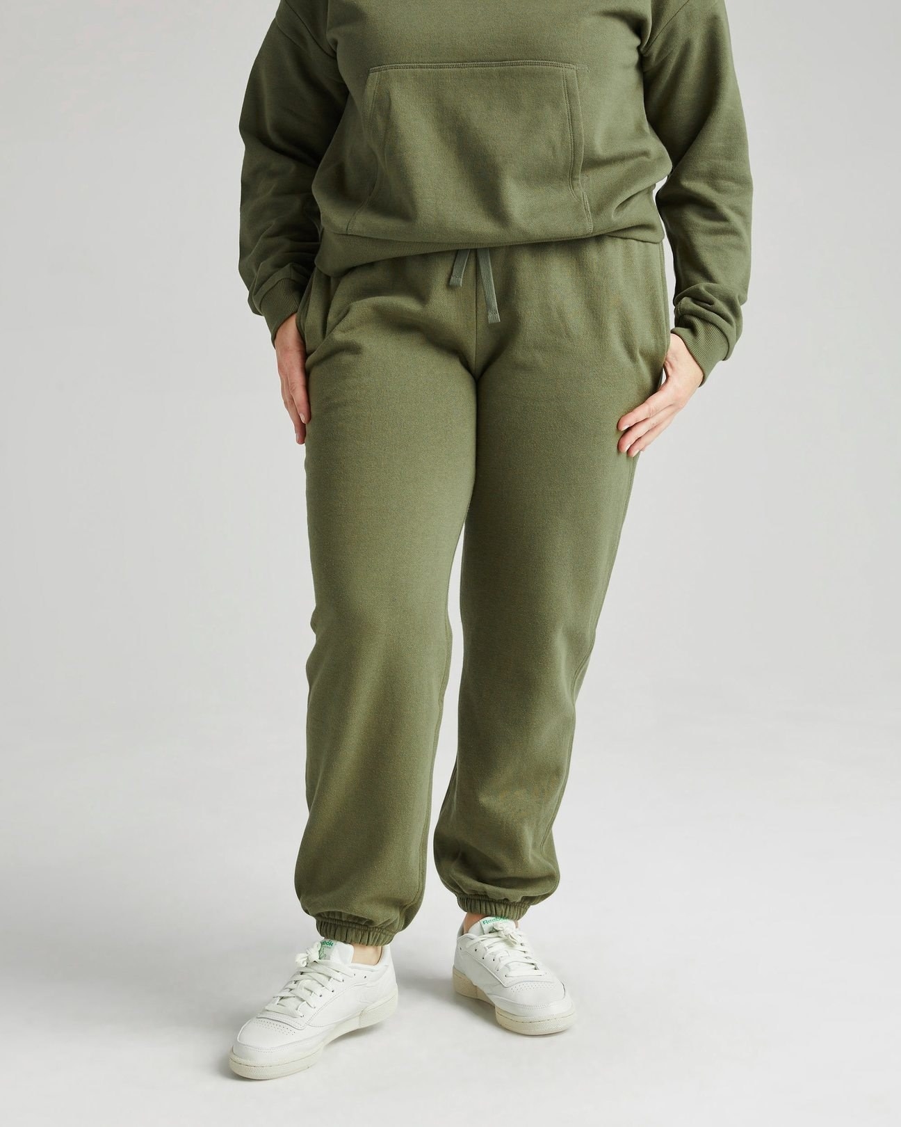 model wearing the green sweatpants