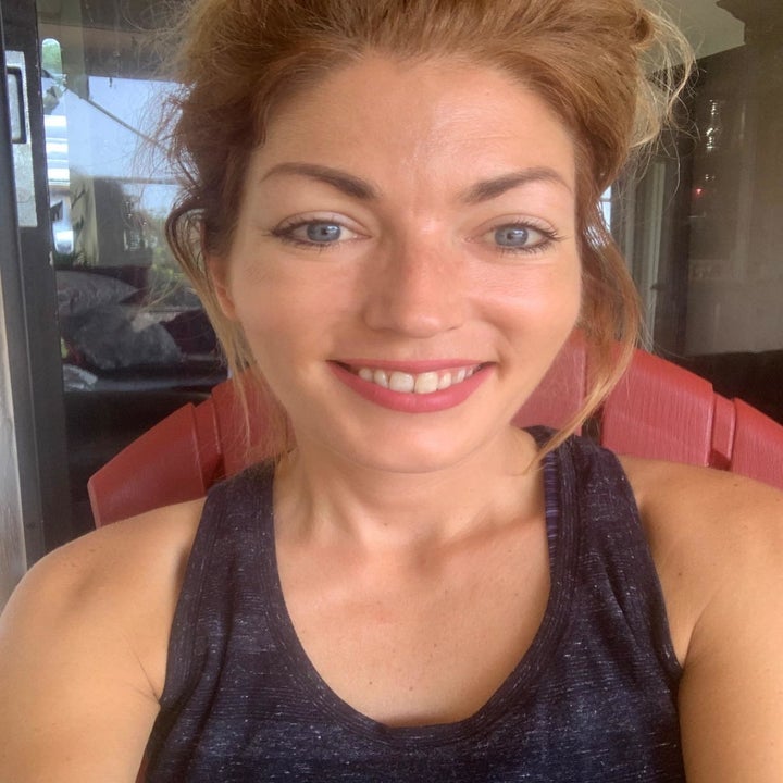 Reviewer with glowing skin after using the moisturizer